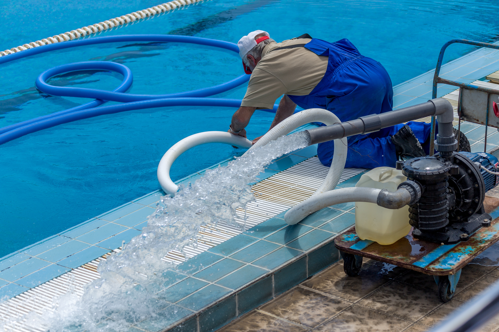 Cleaning the sports pool with a cleaning water pump. The water pump filters the water from the bottom of the pool, cleans from dirt and debris. The cleaning pump works with the pool.